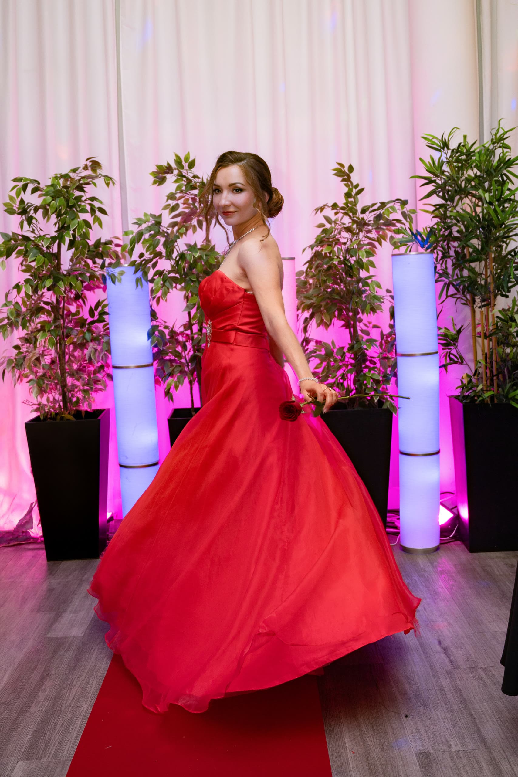 Anastasiia spinning in a red gown