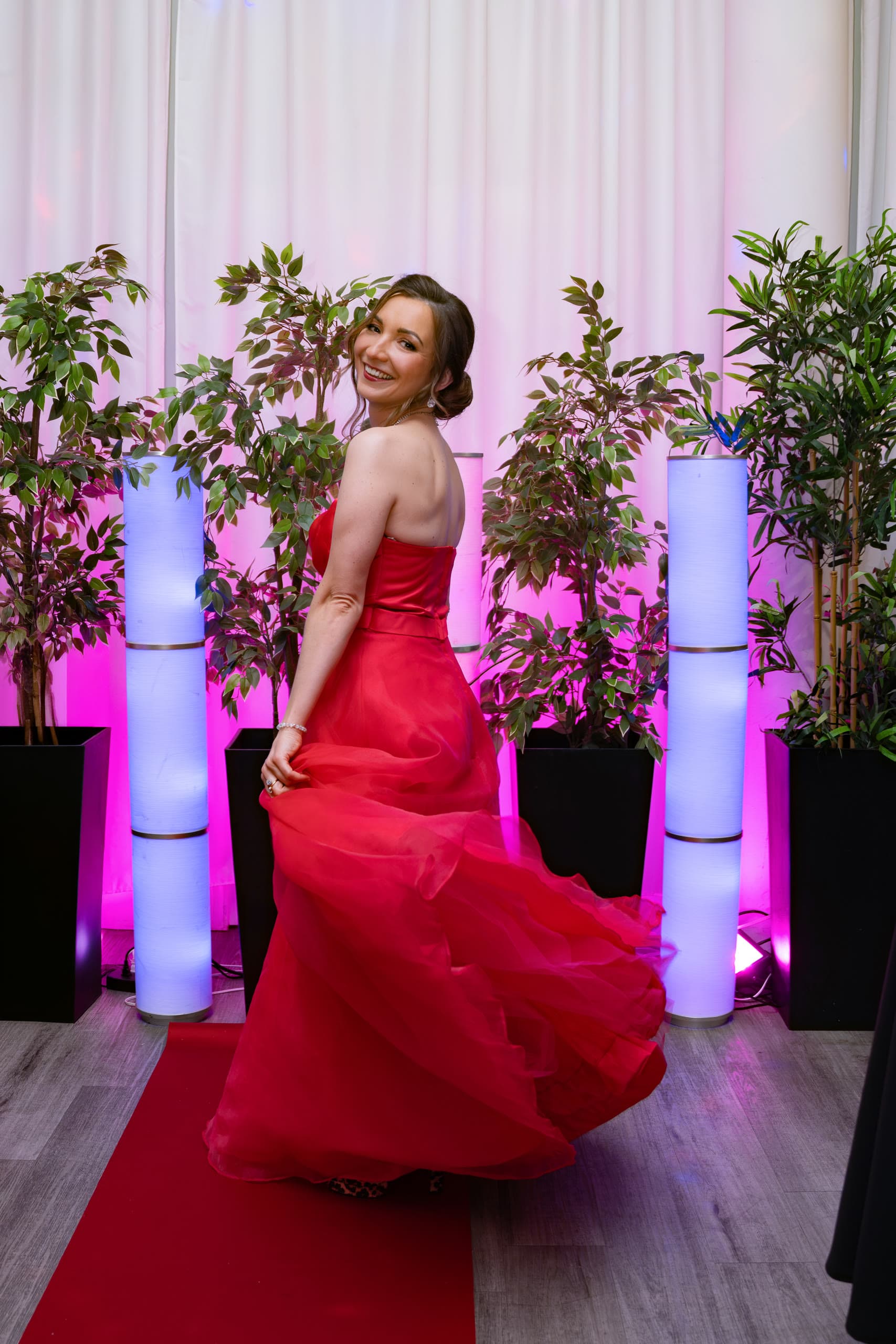 Dramatic swirl of a red gown on the red carpet